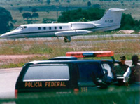 Mexican police prepare to raid a drug smuggling aircraft.